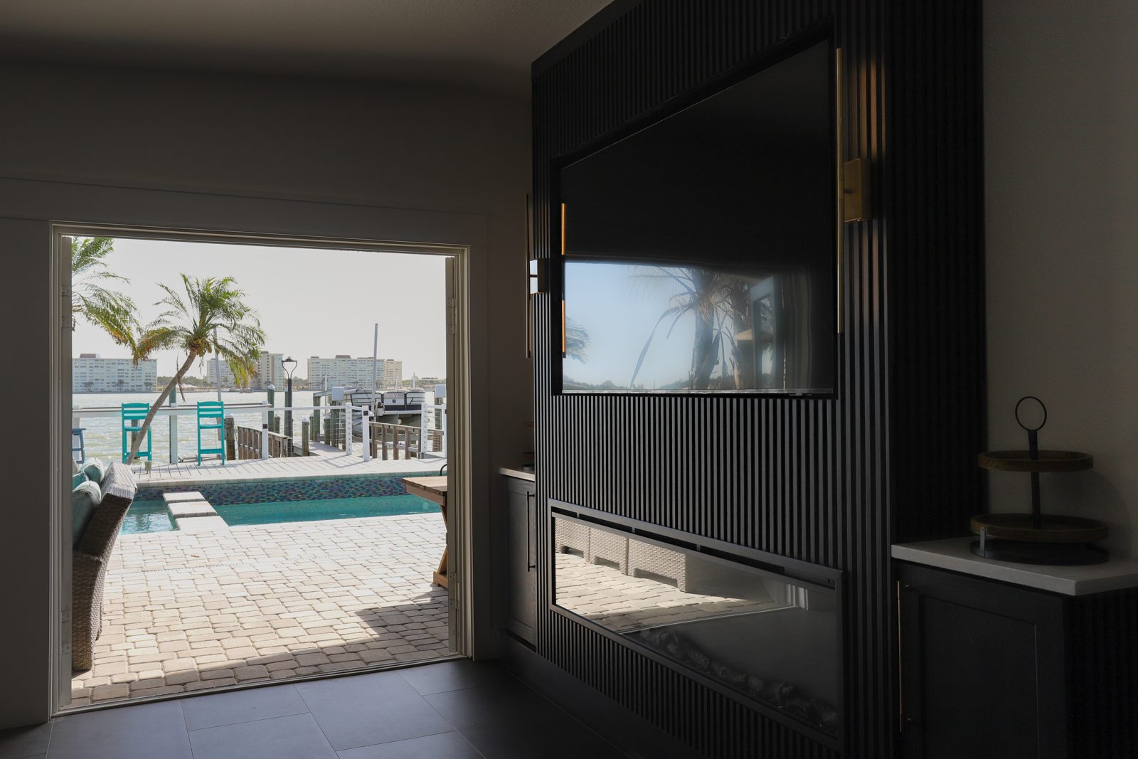 Luxury modern living room opening to a pool and waterfront in a Treasure Island custom home